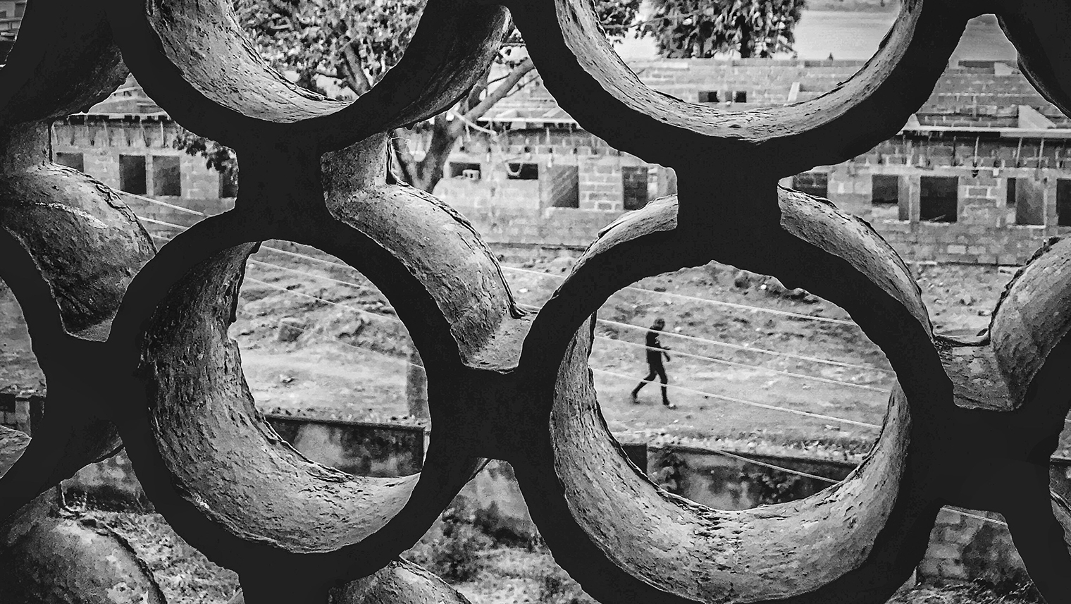 Image of individual walking through derelict building site