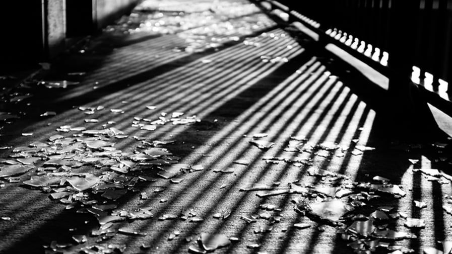 Greyscale shot of a ground with reflections of lines creating a symmetric pattern