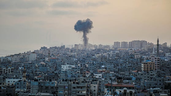 A large city with a large plume of smoke