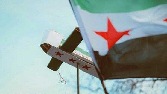 Syria flag and cardboard paper plane 