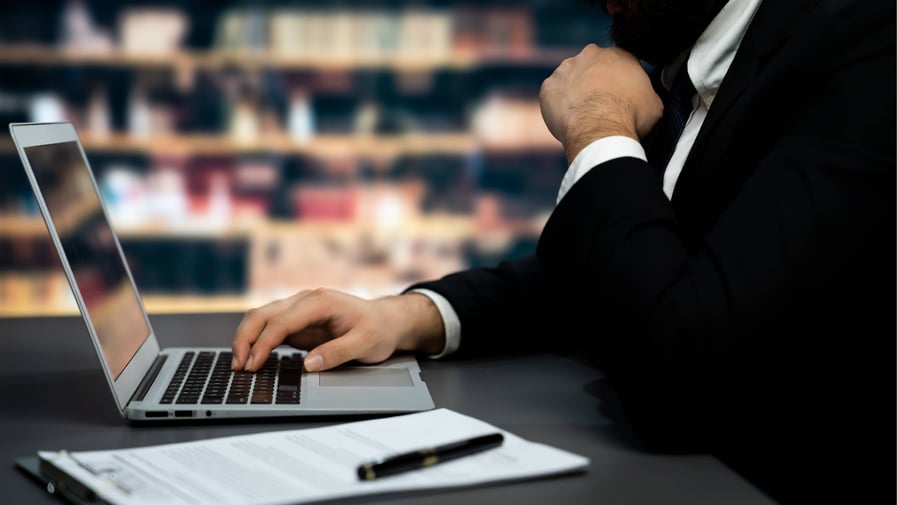 Lawyer sitting in his office looking at emails