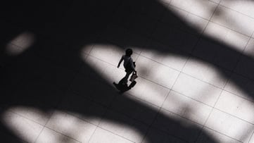Arial photograph of Person with a briefcase walking